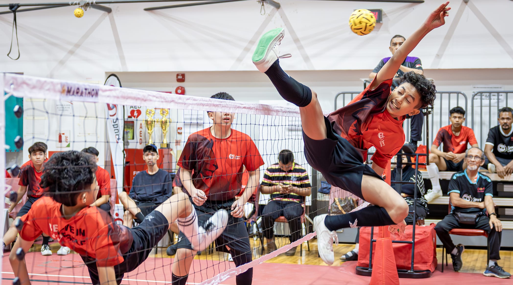 Youth playing sepak takraw